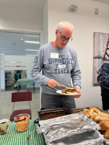 Al serving up a hot sandwich at our Thursday Lunch