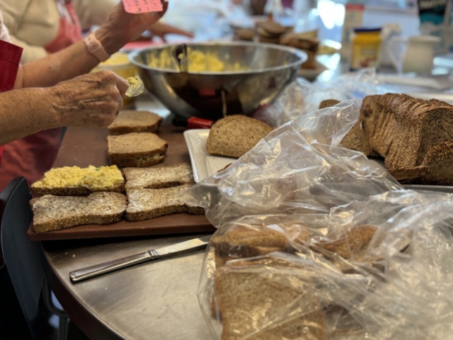 Volunteers making egg salad sandwiches in our kitchen